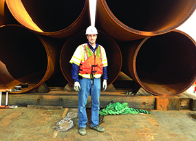 Image of Tony Canale '94 in front of construction materials.